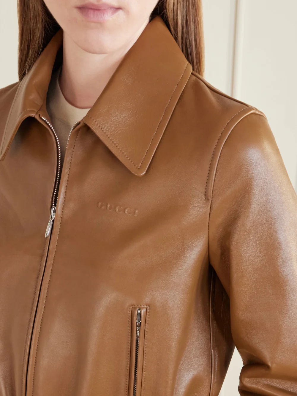 Close-up detail of the Gucci Cropped Embossed Leather Bomber Jacket