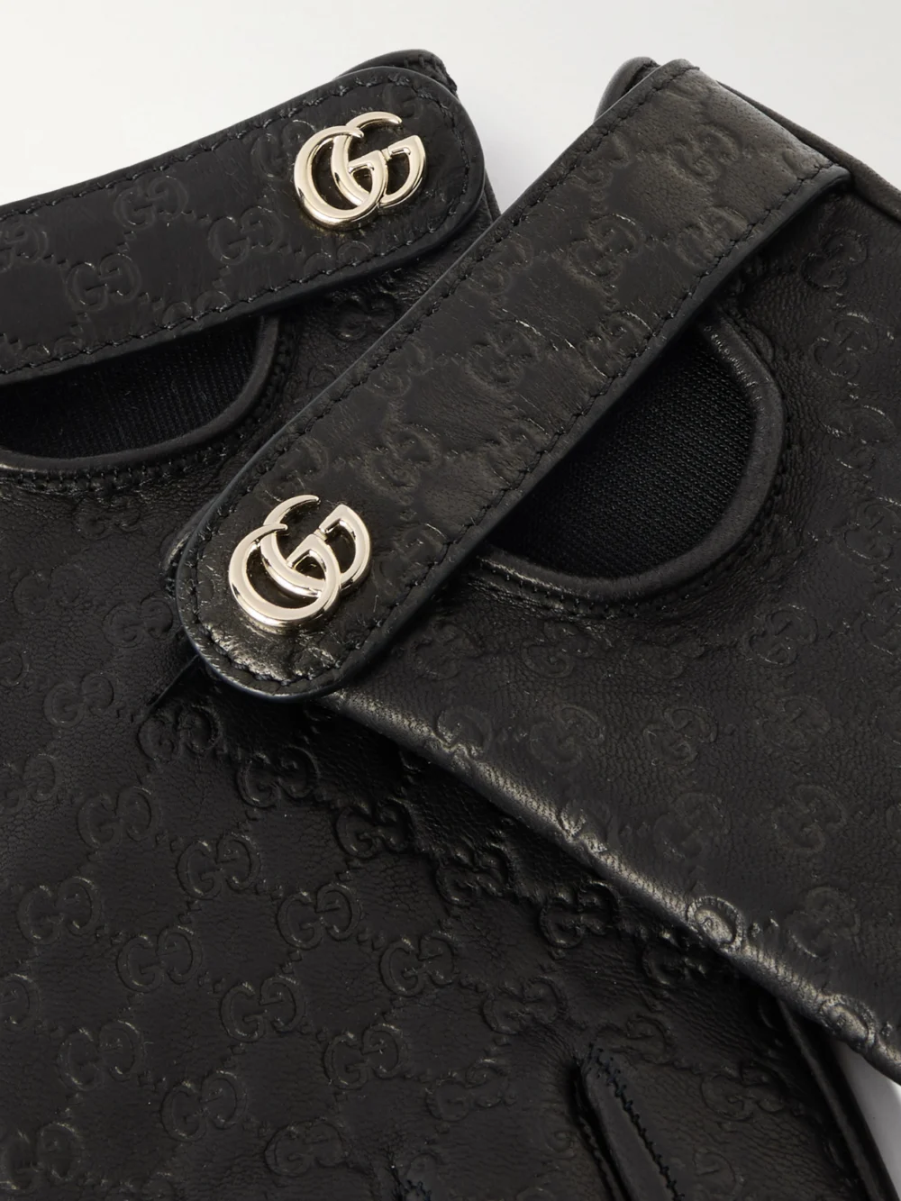 Close-up detail of the Gucci Debossed Leather Gloves