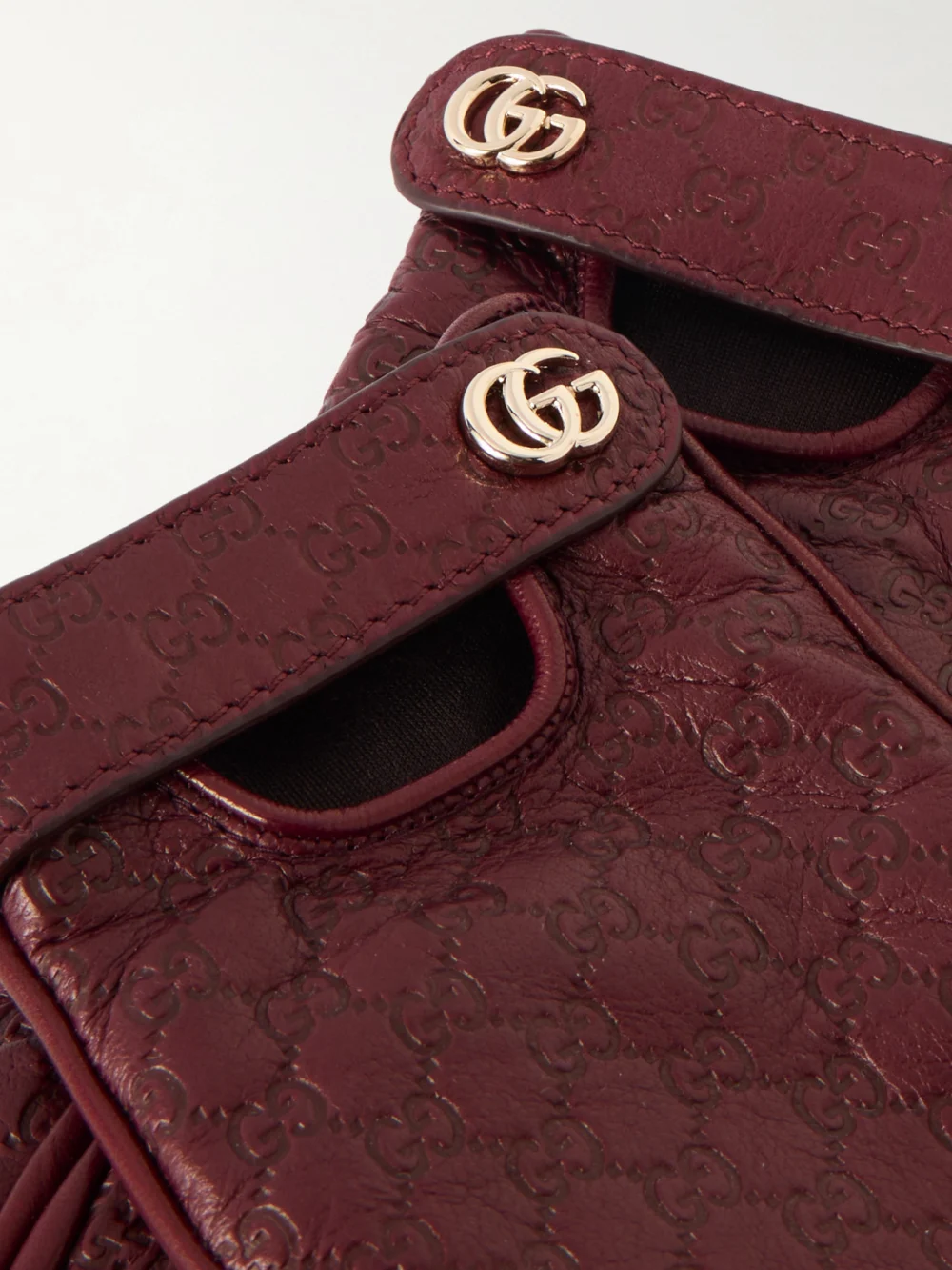 Close-up detail of the Gucci Debossed Leather Gloves