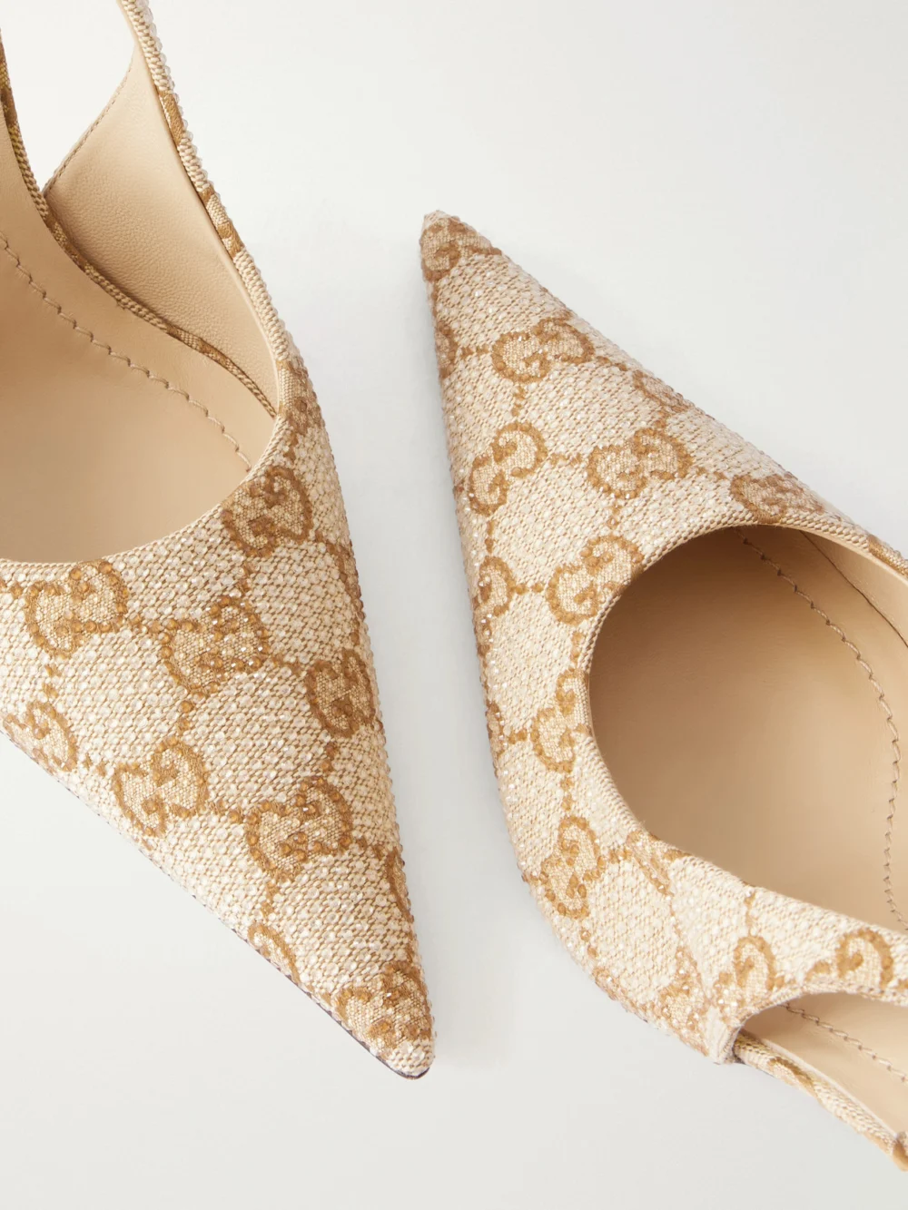 Close-up detail of the Gucci Donna 80 Embellished Gg Supreme Canvas-jacquard Slingback Pumps