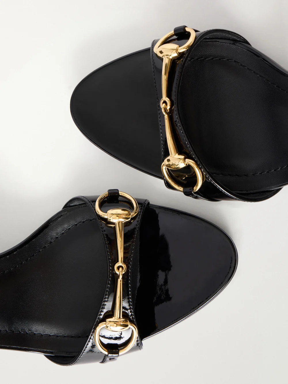 Close-up detail of the Gucci Donna 80 Horsebit-embellished Patent-leather Wedge Sandals