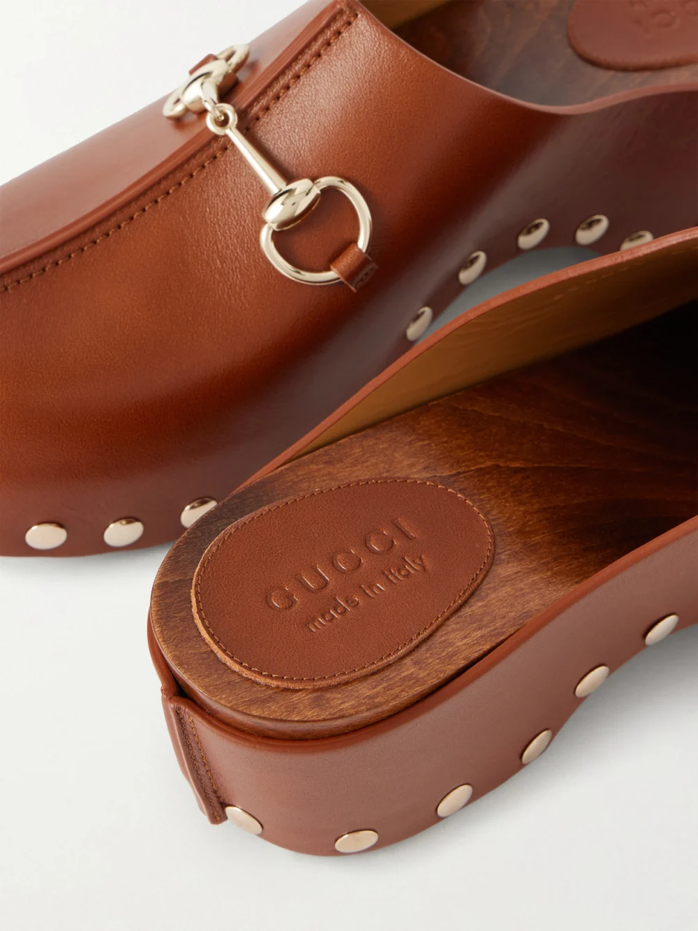 Close-up detail of the Gucci Embellished Studded Leather Clogs