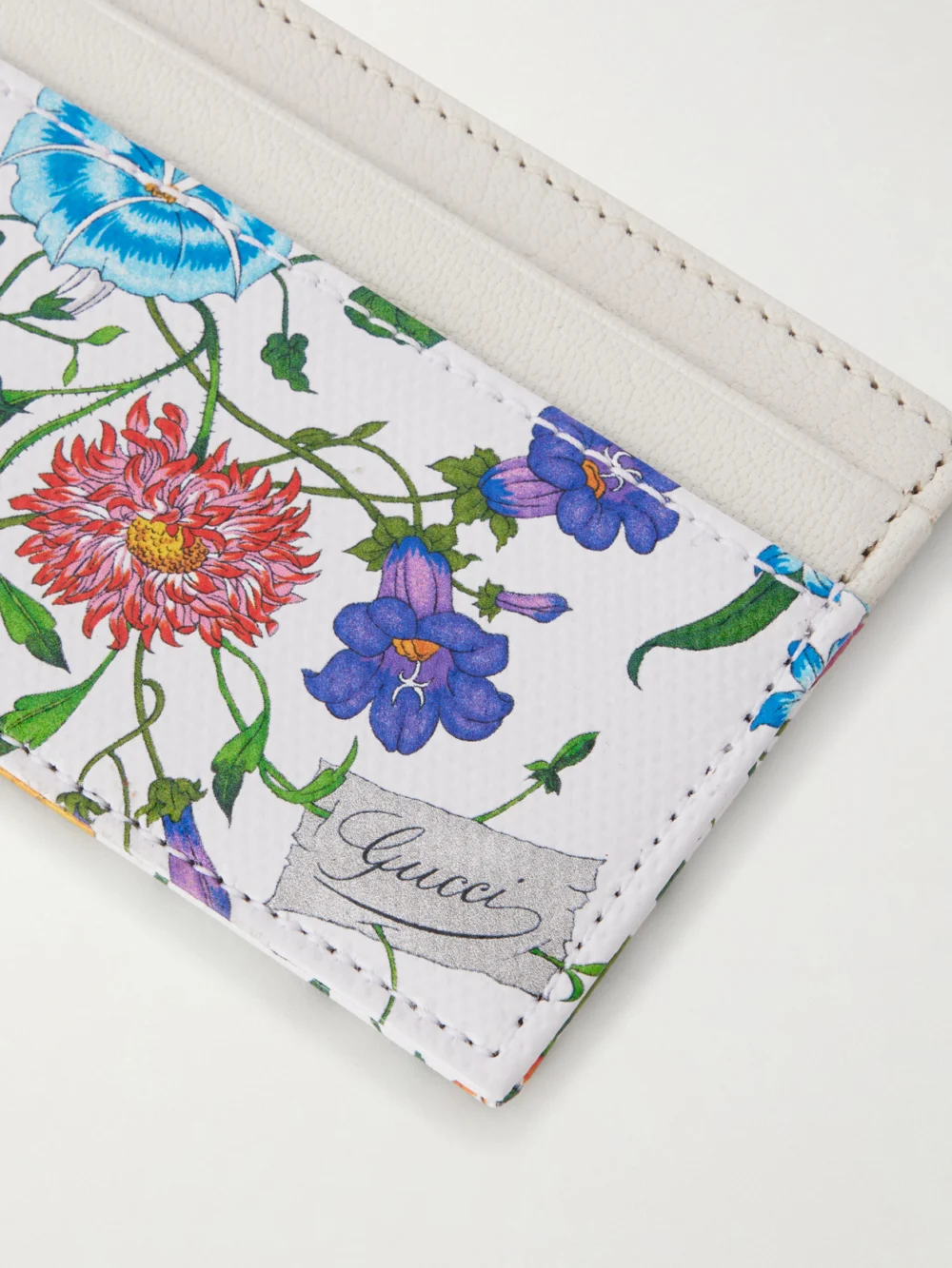 Close-up detail of the Gucci Floral-print Leather Cardholder