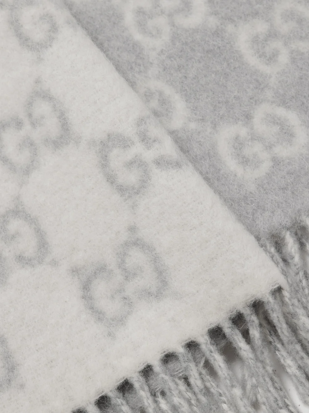 Close-up detail of the Gucci Fringed Jacquard-knit Scarf