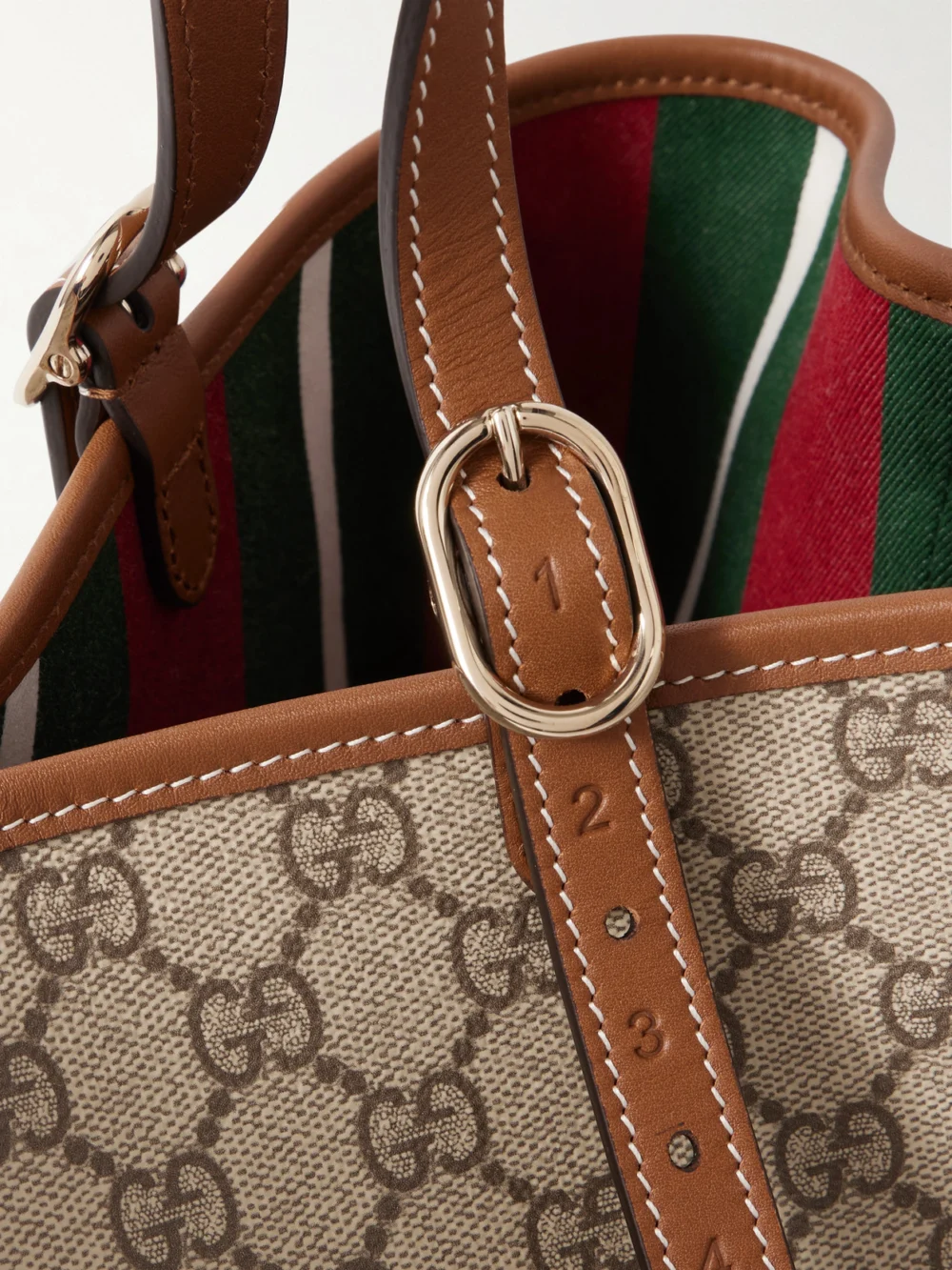 Close-up detail of the Gucci Gg Emblem Leather-trimmed Coated Canvas-jacquard Tote