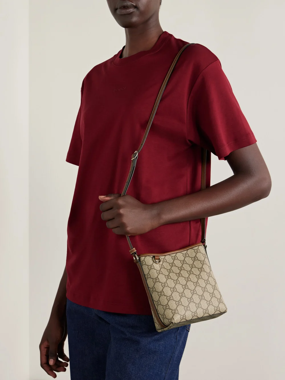 Gucci Gg Emblem Mini Leather-trimmed Coated Canvas-jacquard Shoulder Bag, styled view