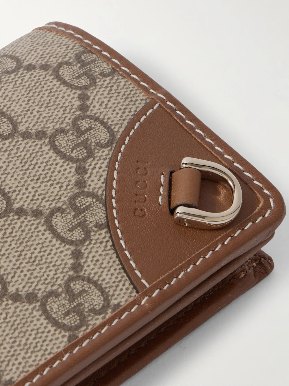 Close-up detail of the Gucci Gg Emblem Mini Printed Coated-canvas and Leather Wallet