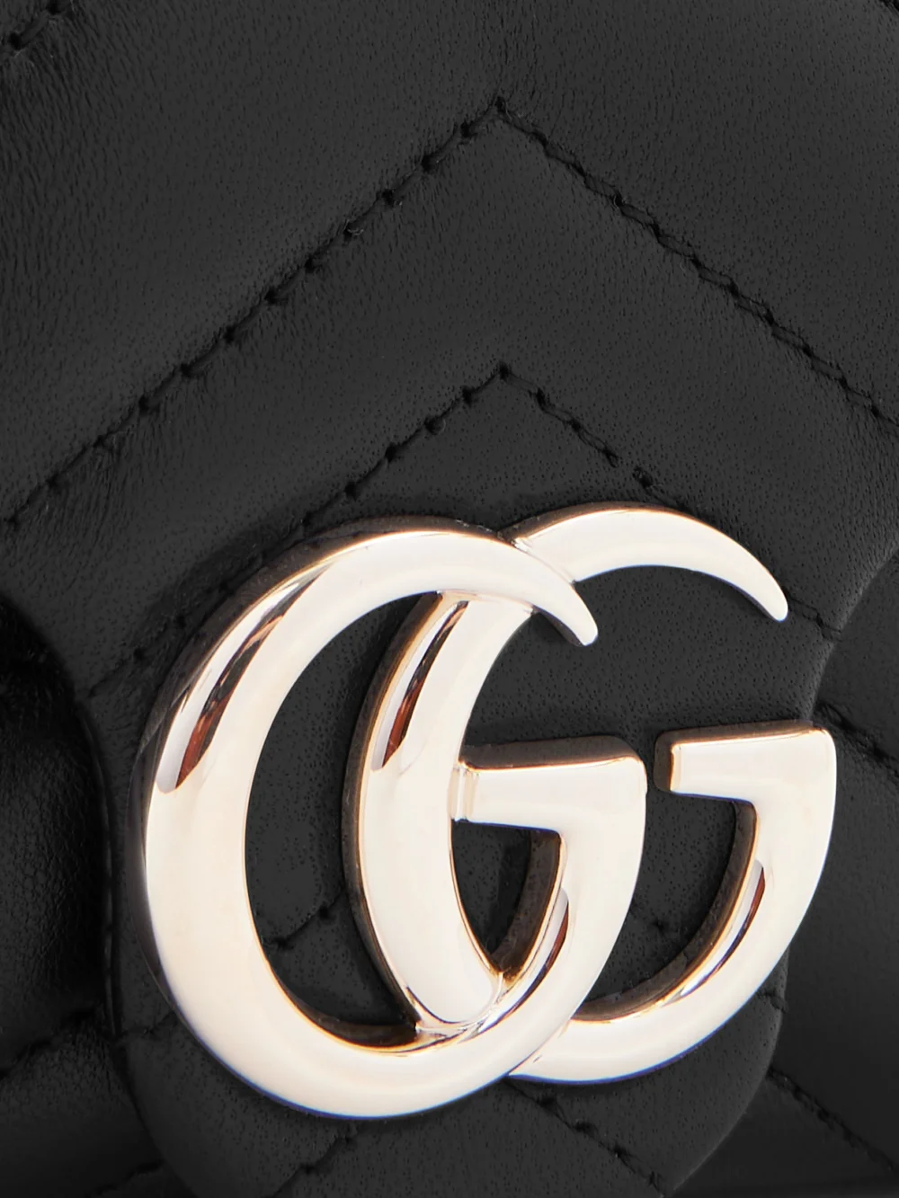Close-up detail of the Gucci Gg Marmont Mini Matelassé Leather Shoulder Bag