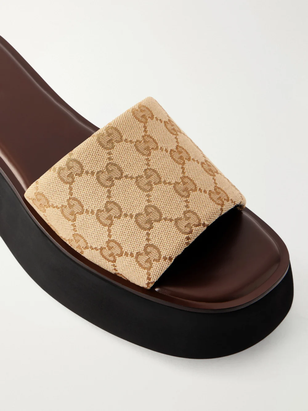Close-up detail of the Gucci Gg Supreme-jacquard Canvas Platform Slides