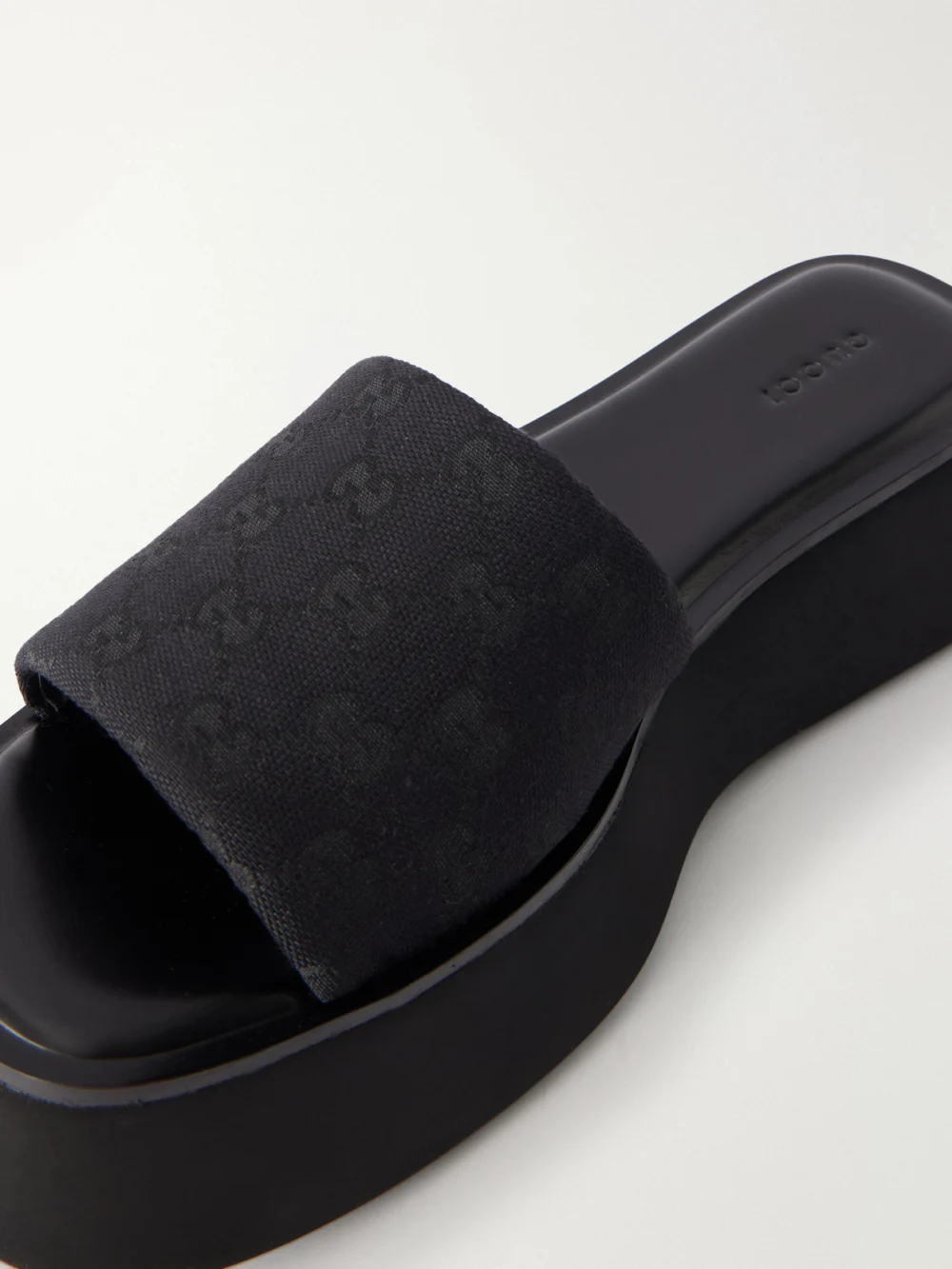 Close-up detail of the Gucci Gg Supreme-jacquard Leather-trimmed Canvas Platform Slides