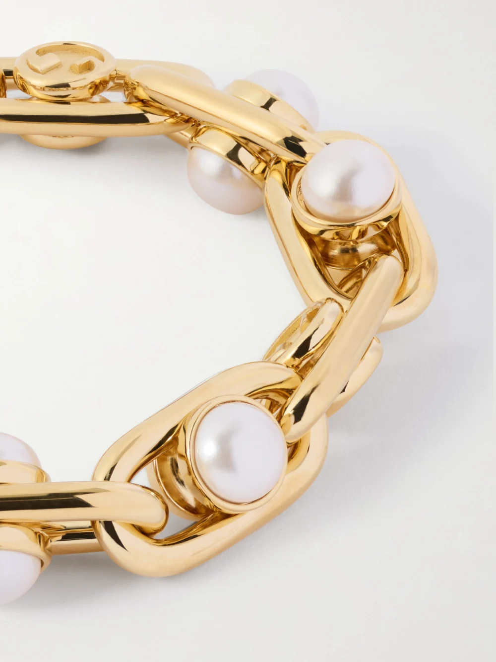 Close-up detail of the Gucci Gold-tone Pearl-like Bracelet