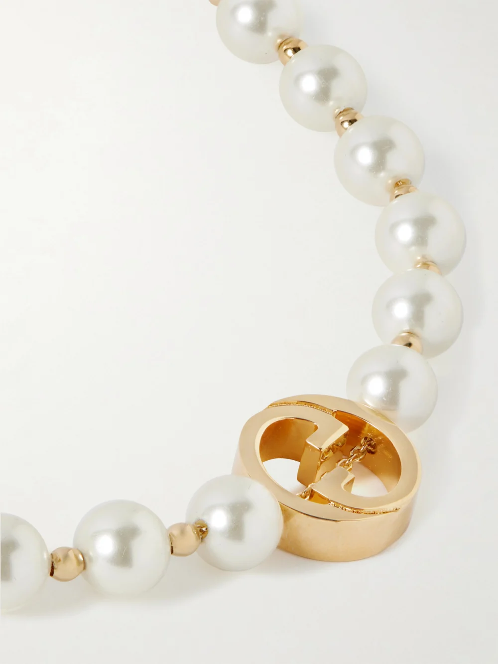 Close-up detail of the Gucci Interlocking G Gold-tone Pearl-like Necklace