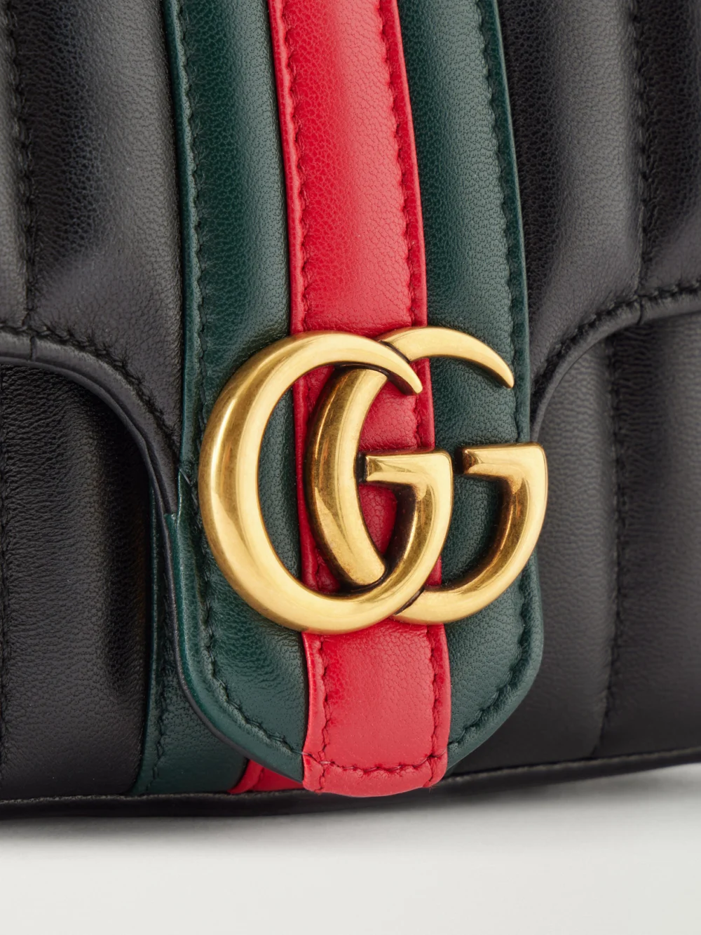 Close-up detail of the Gucci Jetset Gg Marmont Web-trimmed Quilted Leather Crossbody Bag