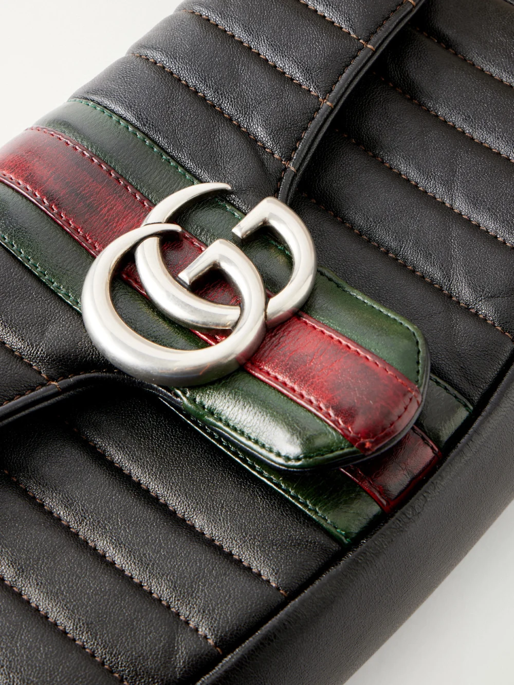 Close-up detail of the Gucci Jetset Gg Marmont Web-trimmed Quilted Leather Shoulder Bag