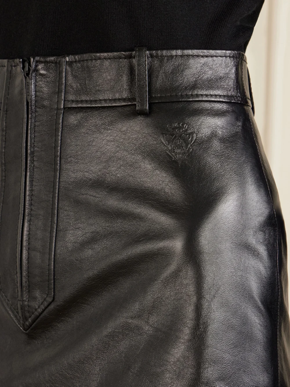Close-up detail of the Gucci Leather Mini Skirt