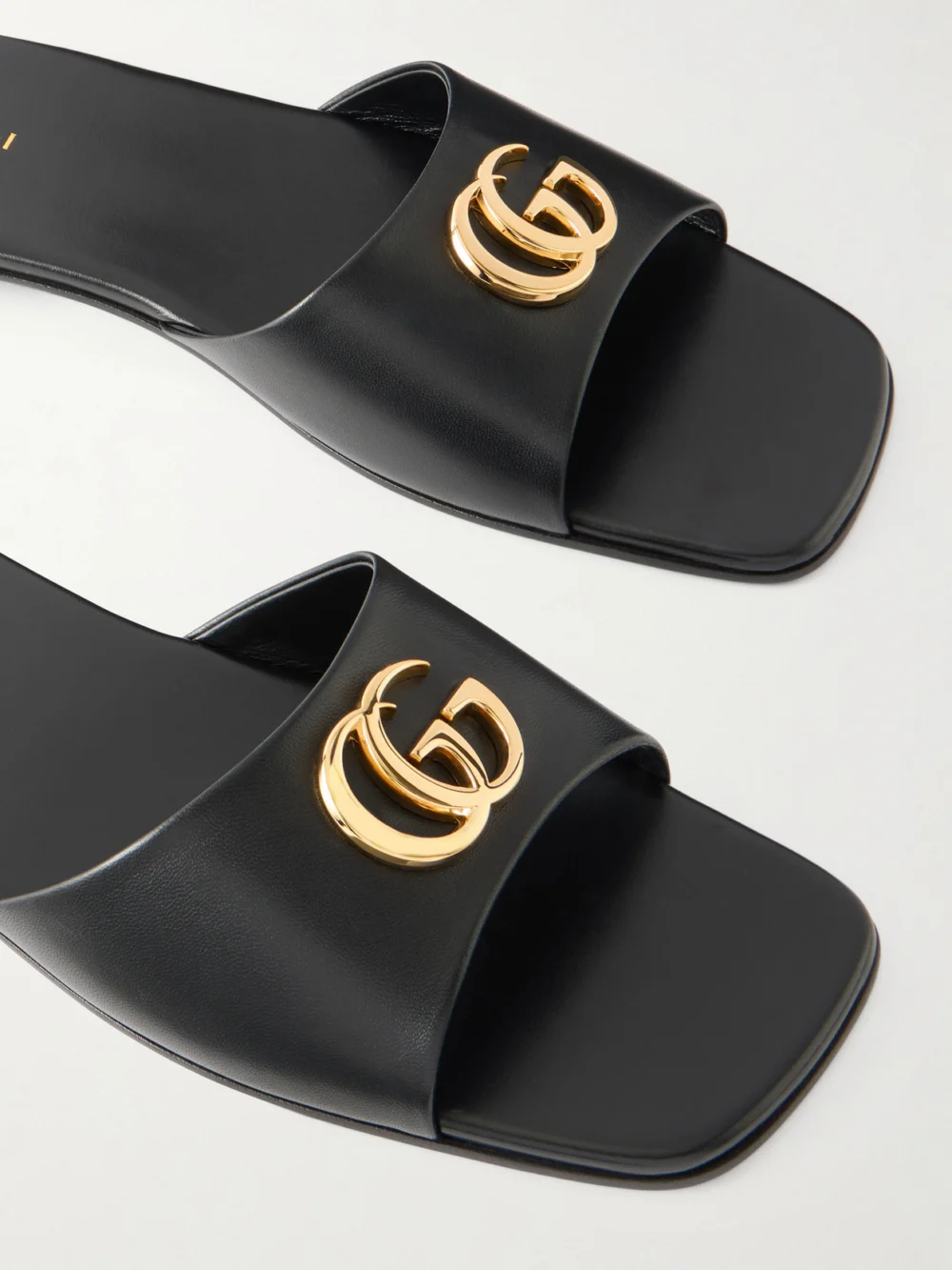 Close-up detail of the Gucci Logo-embellished Leather Slides