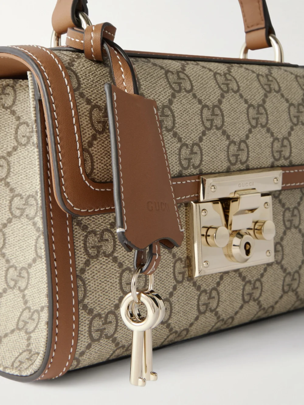 Close-up detail of the Gucci Padlock Small Leather-trimmed Coated Canvas-jacquard Top-handle Bag