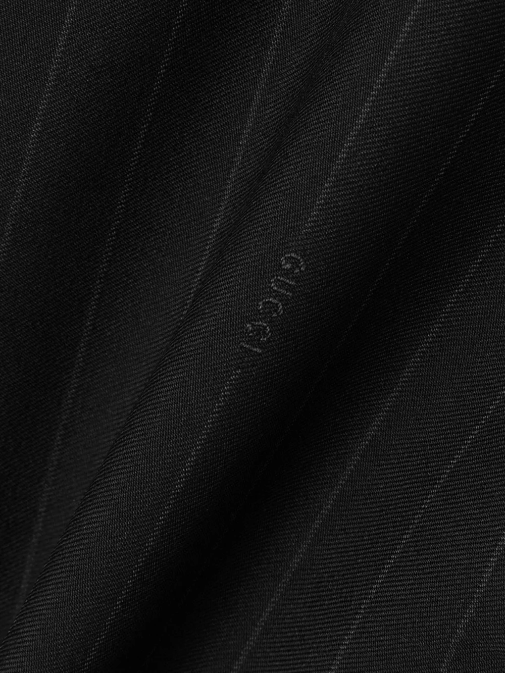 Close-up detail of the Gucci Pinstriped Wool-twill Wide-leg Pants