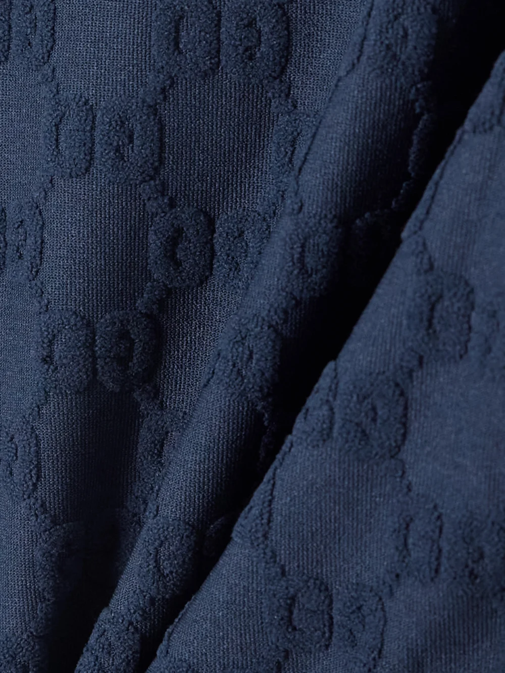 Close-up detail of the Gucci Piped Terry-jacquard Swimsuit