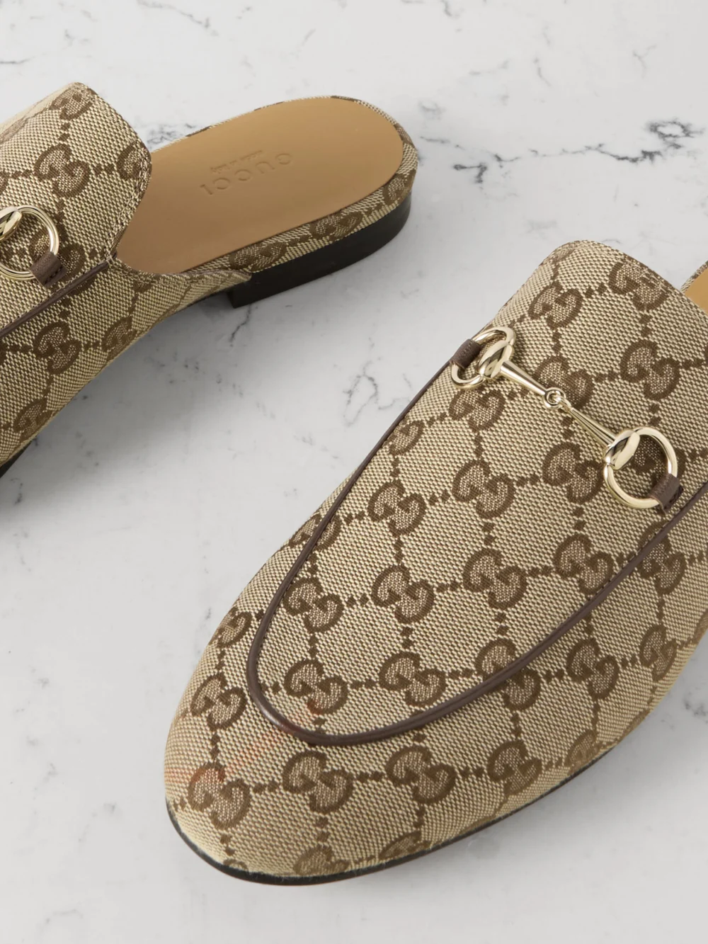 Close-up detail of the Gucci Princetown Horsebit-detailed Leather-trimmed Canvas-jacquard Slippers