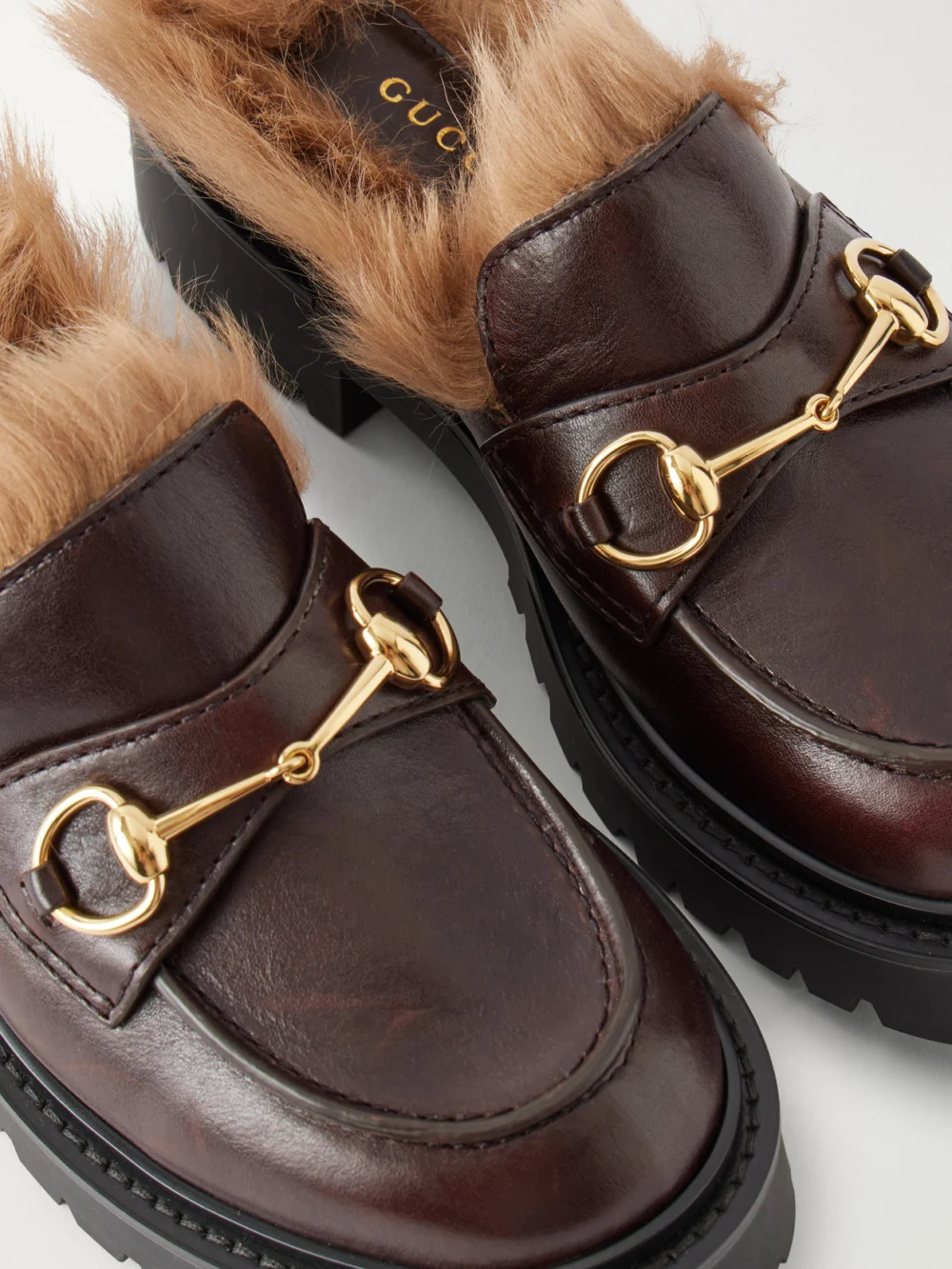 Close-up detail of the Gucci Rhody Horsebit-embellished Shearling-lined Leather Mules