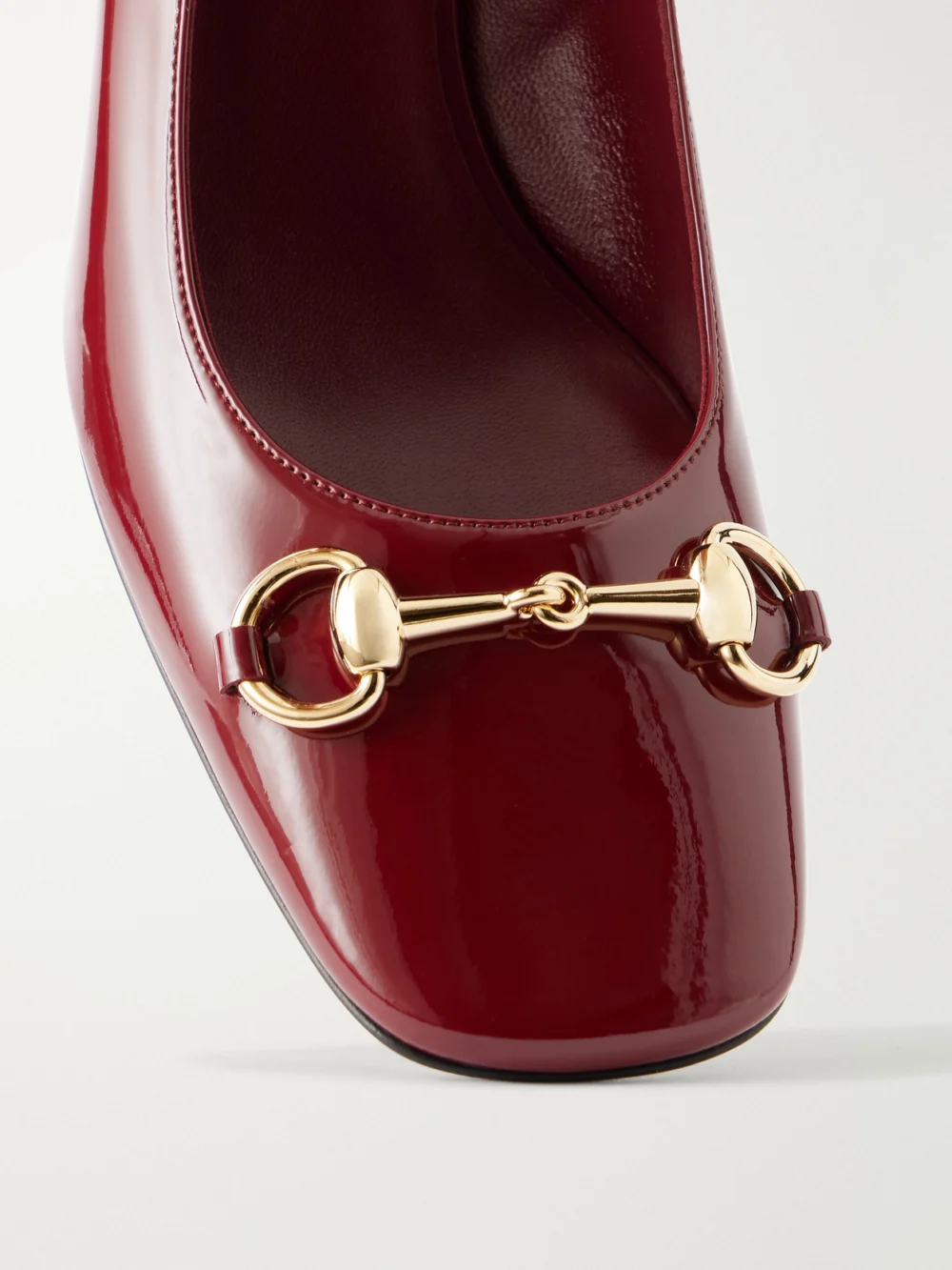 Close-up detail of the Gucci Signora 55 Horsebit-embellished Patent-leather Pumps