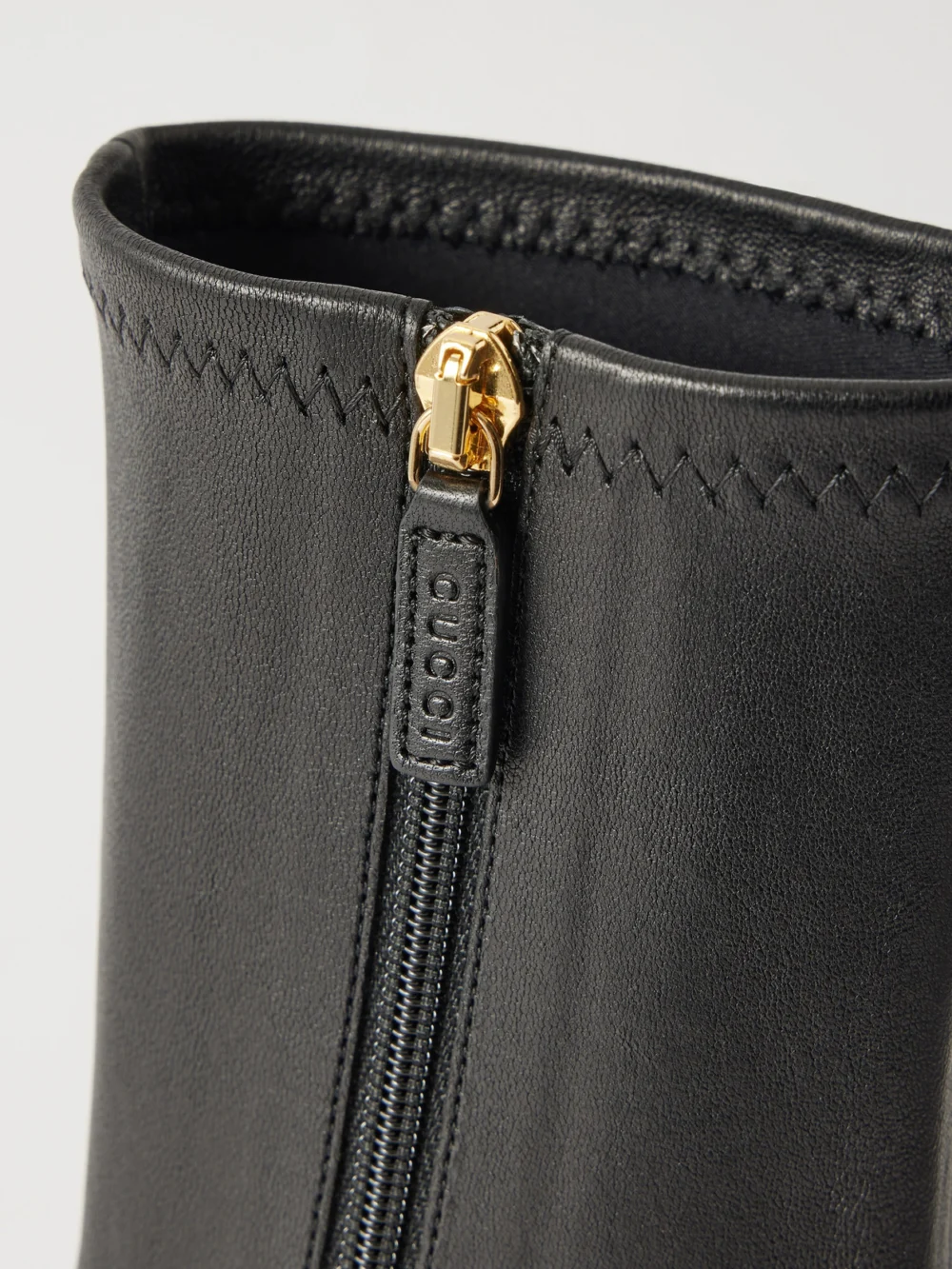 Close-up detail of the Gucci Signora Horsebit-embellished Leather Ankle Boots