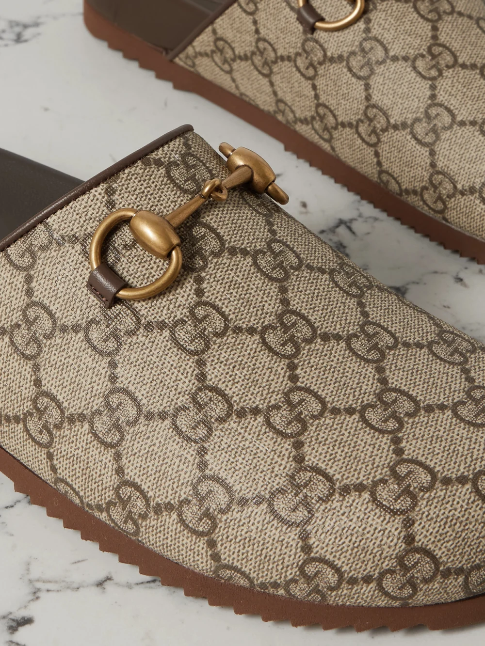 Close-up detail of the Gucci Sol Embellished Leather-trimmed Canvas-jacquard Slippers