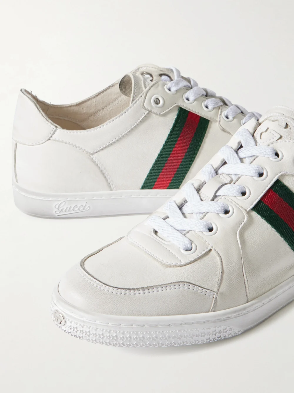 Close-up detail of the Gucci Stretch Distressed Webbing-trimmed Leather Sneakers