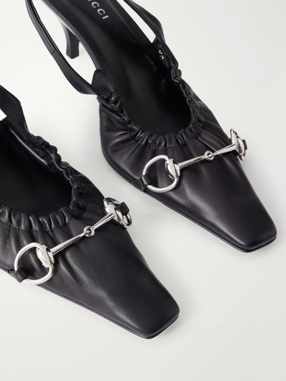 Close-up detail of the Gucci Vittoria 55 Horsebit-embellished Leather Slingback Pumps