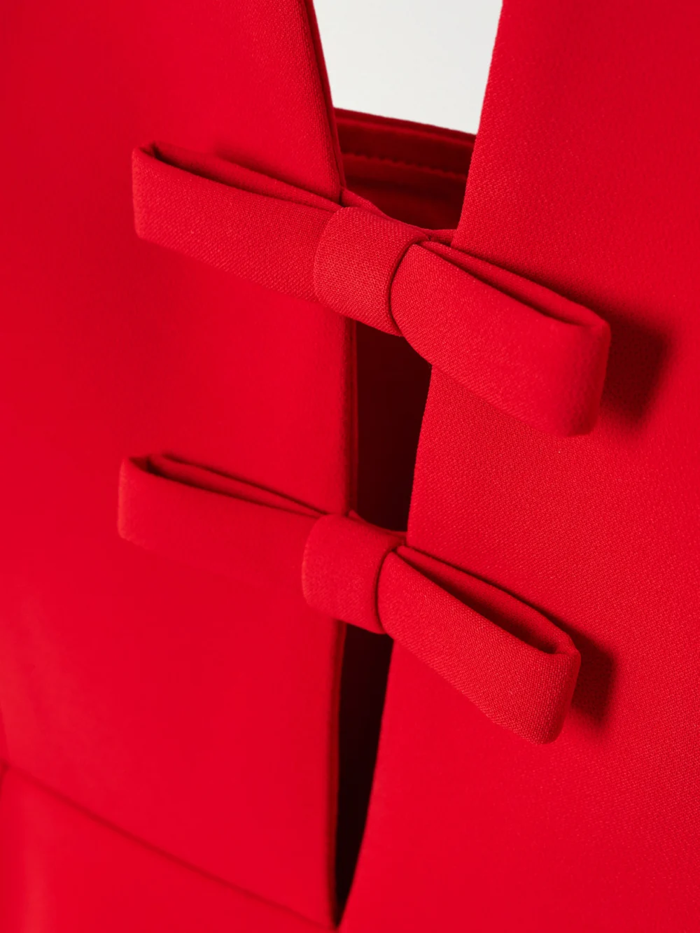 Close-up detail of the Ilkyaz Ozel Noa Strapless Bow-embellished Crepe Gown