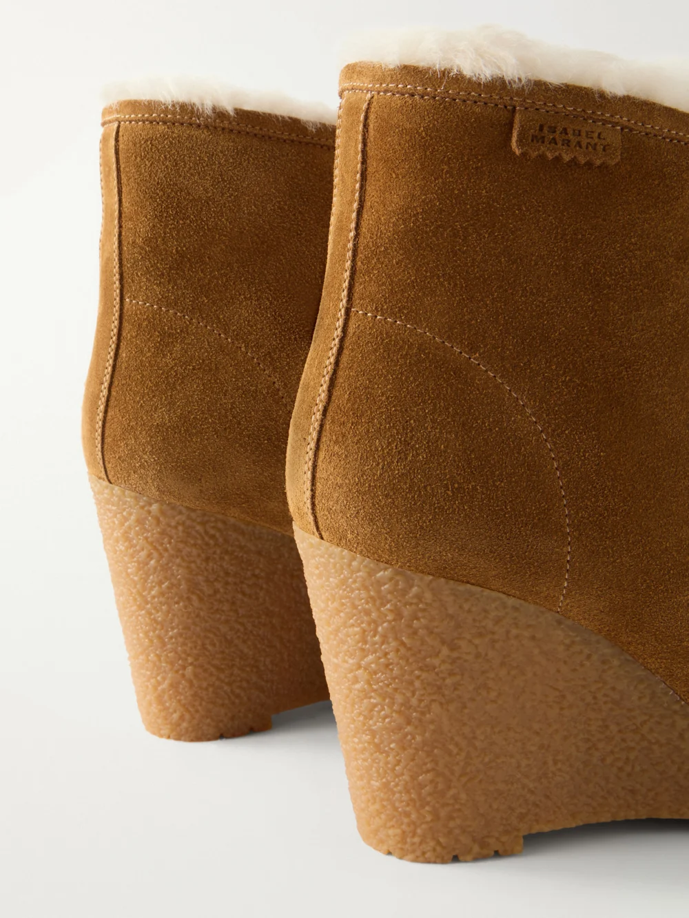 Close-up detail of the Isabel Marant Cylia Shearling-trimmed Suede Wedge Ankle Boots