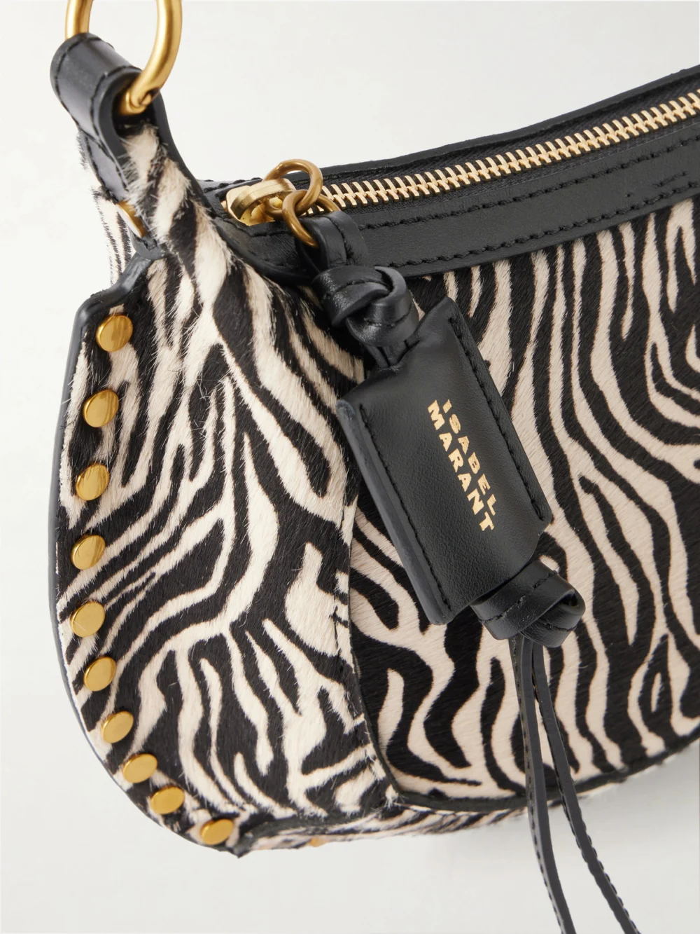 Close-up detail of the Isabel Marant Oskan Moon Zebra-print Leather-trimmed Calf-hair Shoulder Bag