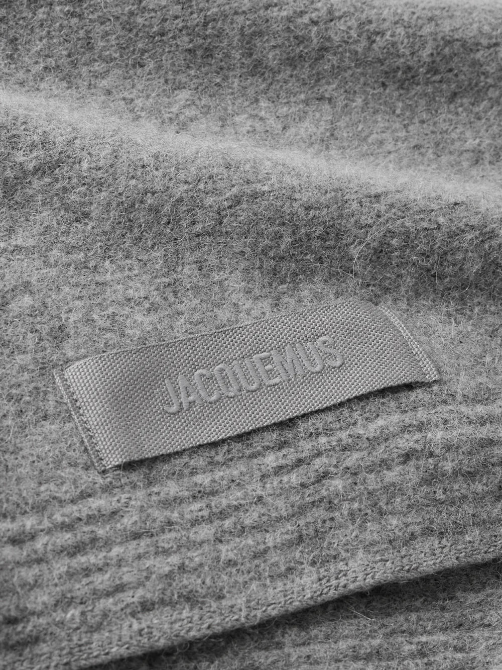 Close-up detail of the Jacquemus Appliquéd Brushed Knitted Scarf