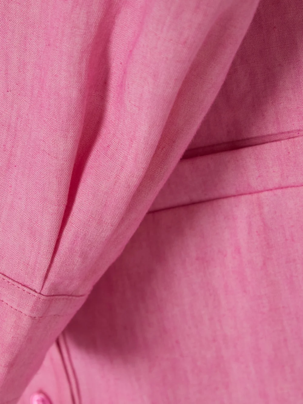 Close-up detail of the Jacquemus Baunhilha Layered Linen Mini Shirt Dress