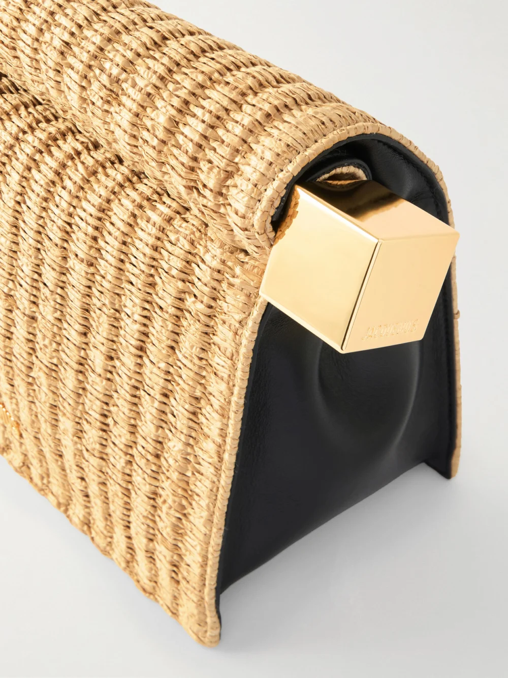 Close-up detail of the Jacquemus La Plage Leather-trimmed Raffia-effect Clutch
