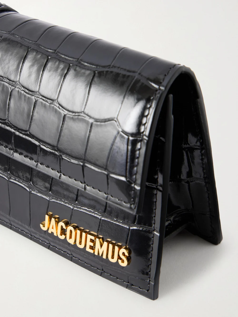 Close-up detail of the Jacquemus La Pochette Bambino Crocodile-effect Leather Clutch