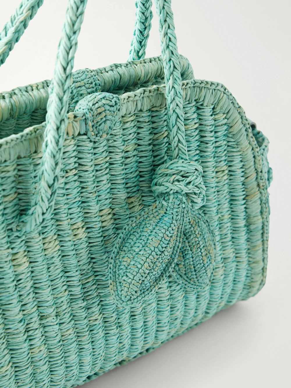 Close-up detail of the Jacquemus Le Petit Turismo Leather-trimmed Raffia Tote Bag