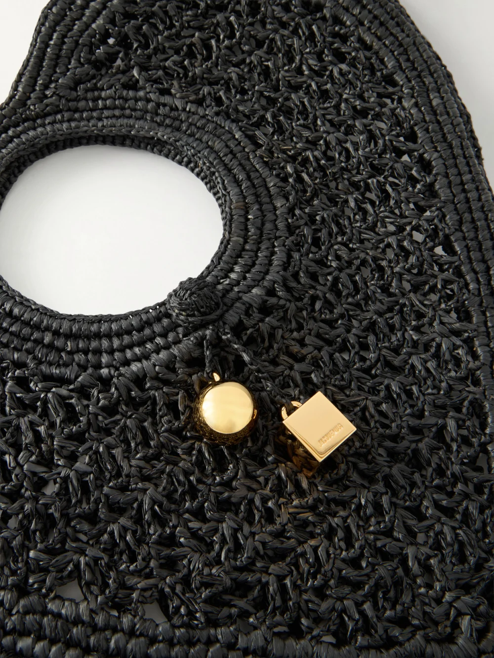 Close-up detail of the Jacquemus Le Spiaggia Coeur Embellished Raffia Tote