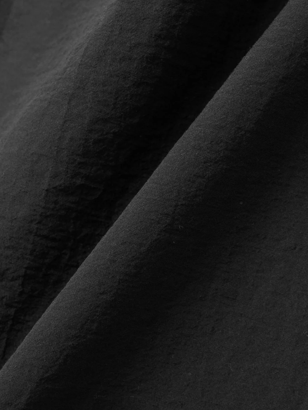 Close-up detail of the Jacquemus The Drapeado Draped Cotton-blend Gauze Midi Dress