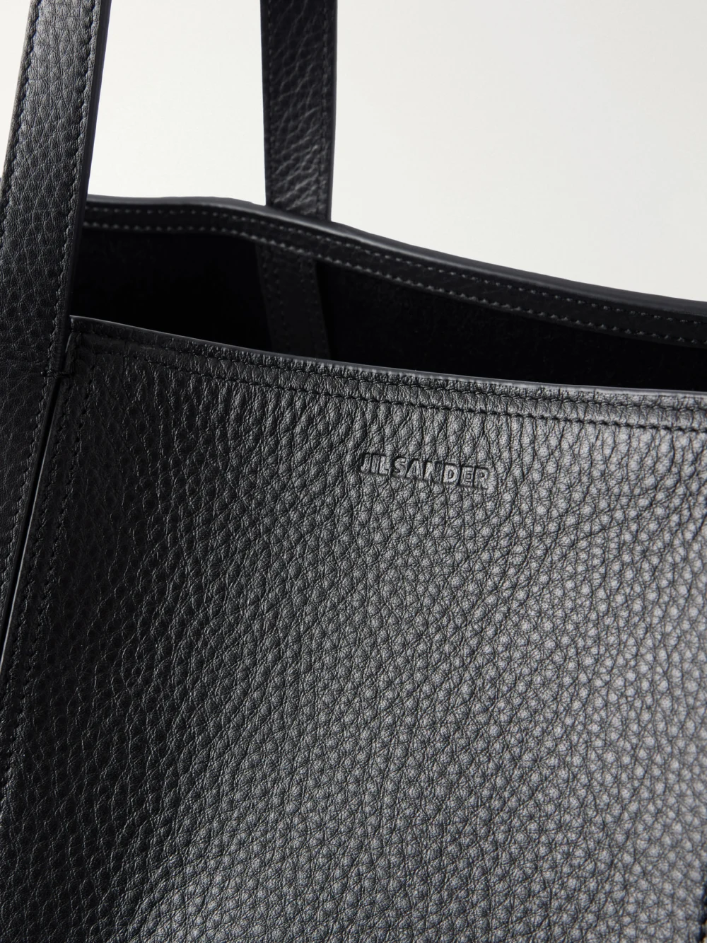 Close-up detail of the Jil Sander Foro Logo-embossed Textured-leather Tote