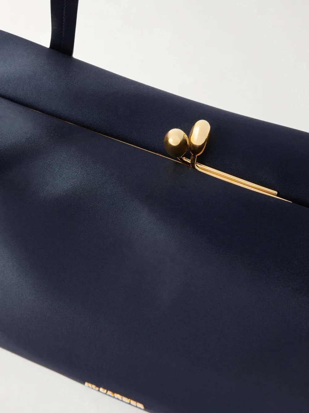 Close-up detail of the Jil Sander Goji Pillow Satin Shoulder Bag