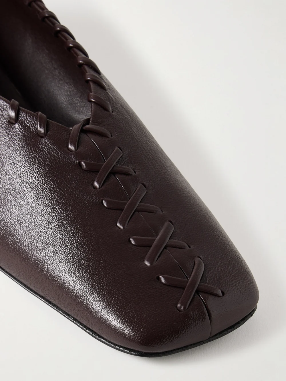 Close-up detail of the Jil Sander Ring Whipstitch-trimmed Leather Ballet Flats