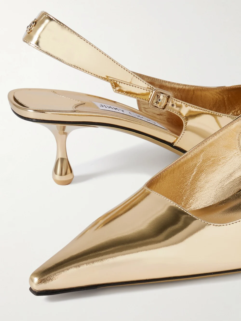 Close-up detail of the Jimmy Choo Amel 50 Logo-embellished Metallic Leather Slingback Pumps
