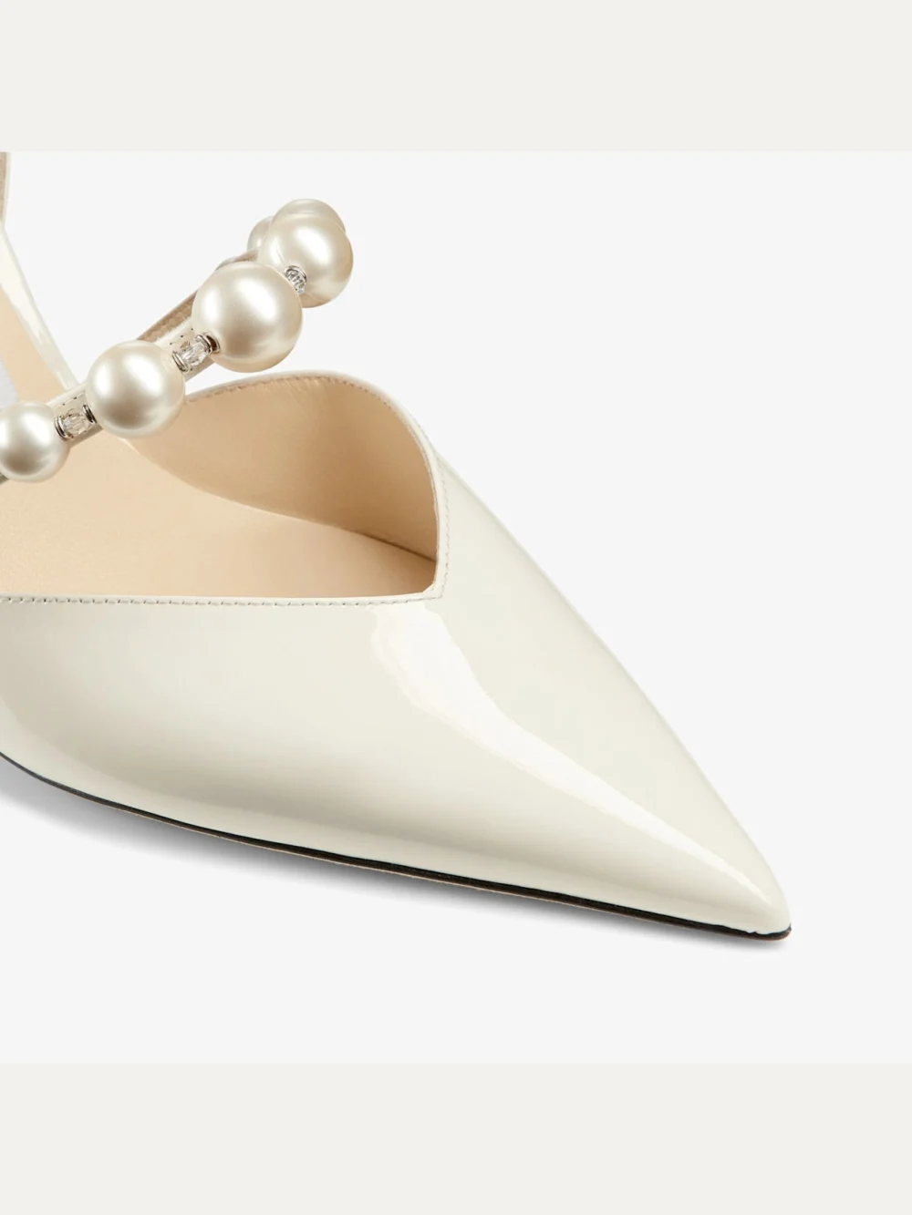 Close-up detail of the Jimmy Choo Aurelie 65 Latte Patent Leather Pointed Pumps with Pearl Embellishment