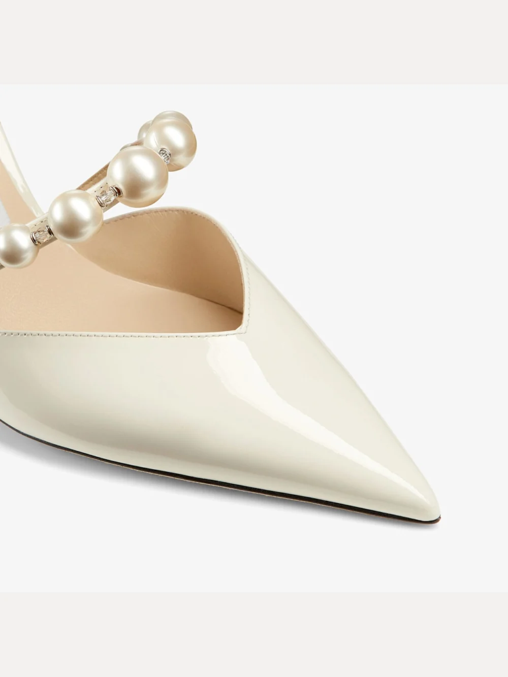 Close-up detail of the Jimmy Choo Aurelie 85 Latte Patent Leather Pointed Pumps with Pearl Embellishment
