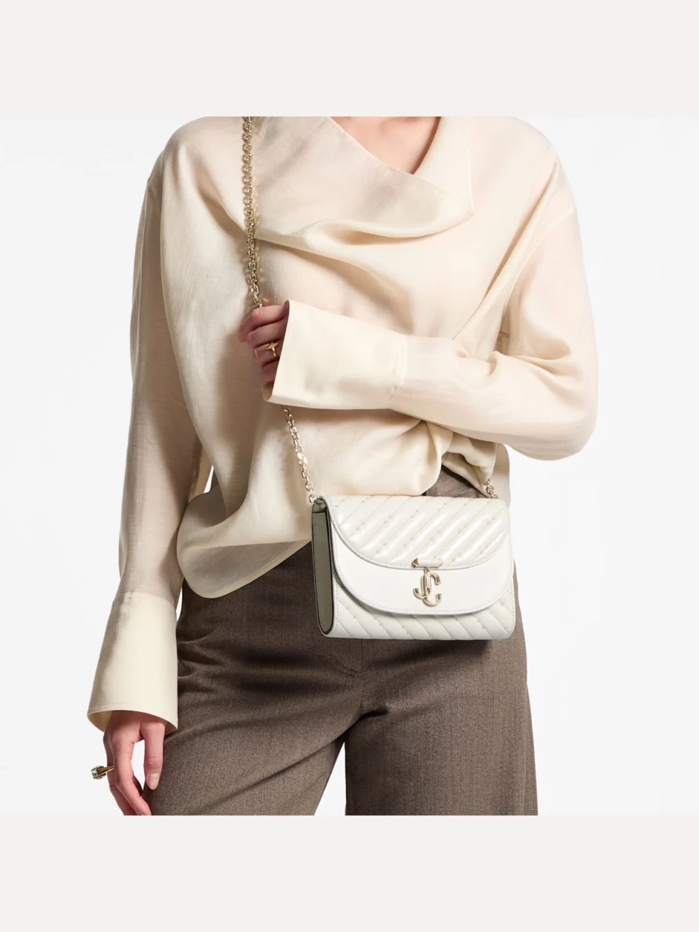 Side view of the Jimmy Choo Avenue Curve Clutch Latte Quilted Nappa Leather Clutch Bag