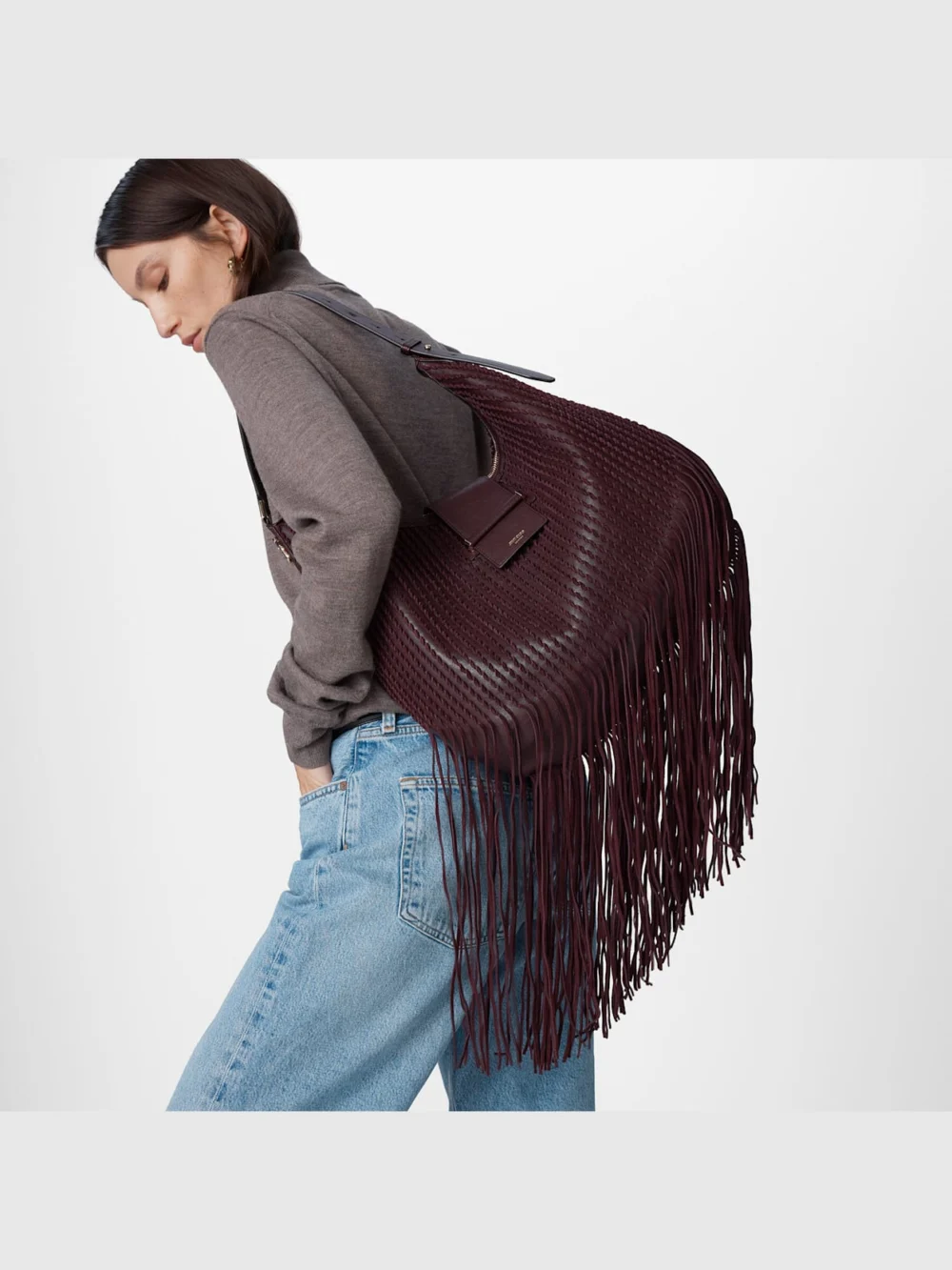 Side view of the Jimmy Choo Bar Hobo Medium Deep Merlot Biker Leather Shoulder Bag with Suede Fringes