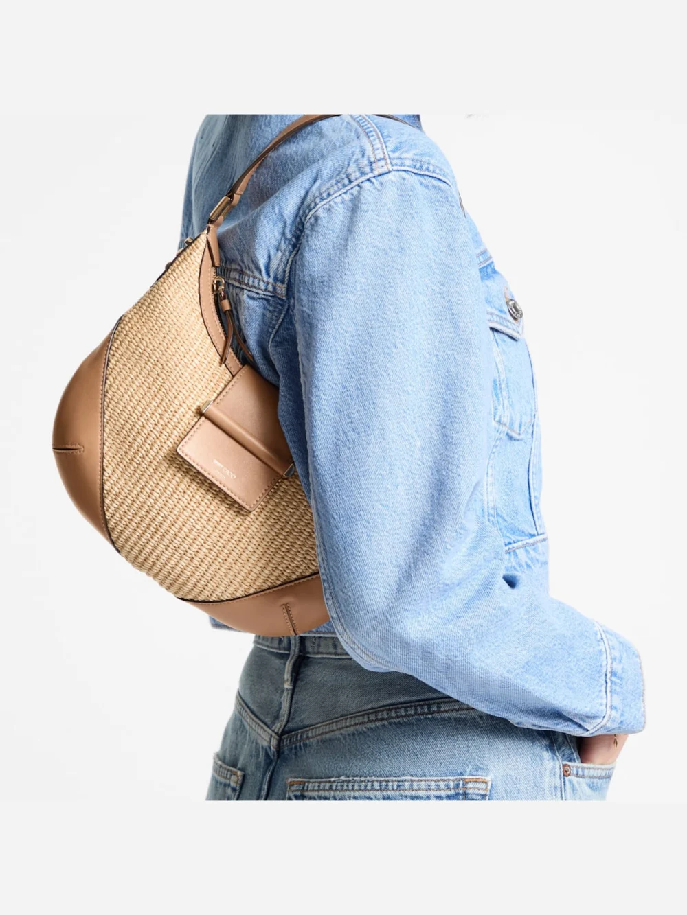 Side view of the Jimmy Choo Bar Hobo Small Natural and Toffee Raffia Shoulder Bag with Smooth Calf Leather Trim