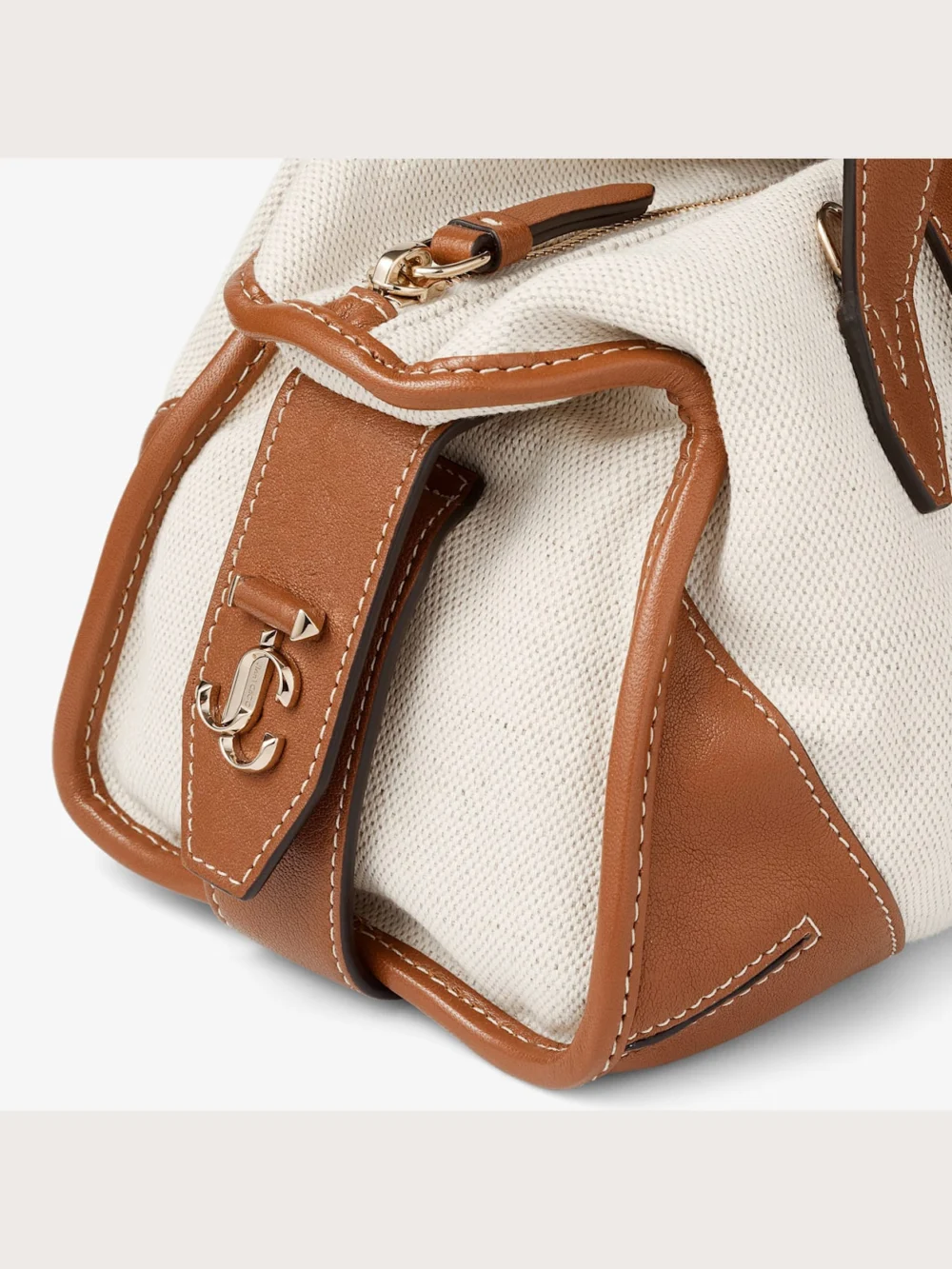Close-up detail of the Jimmy Choo Bar Holdall Small Natural and Tan Recycled Canvas Holdall Bag with Biker Leather Trim